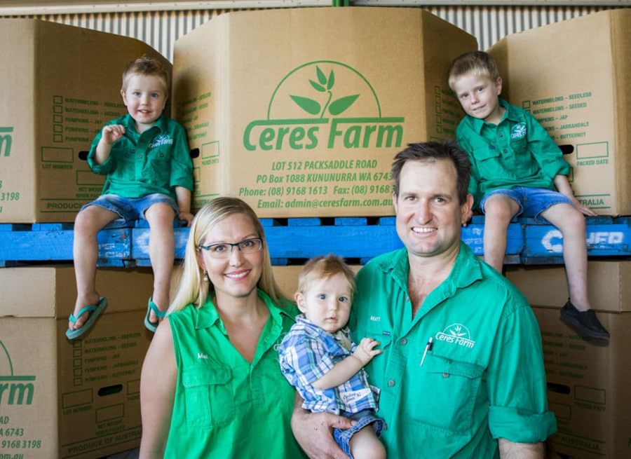 Matthew and Melanie Gray with their three young sons in front of stacked Ceres Farm cartons