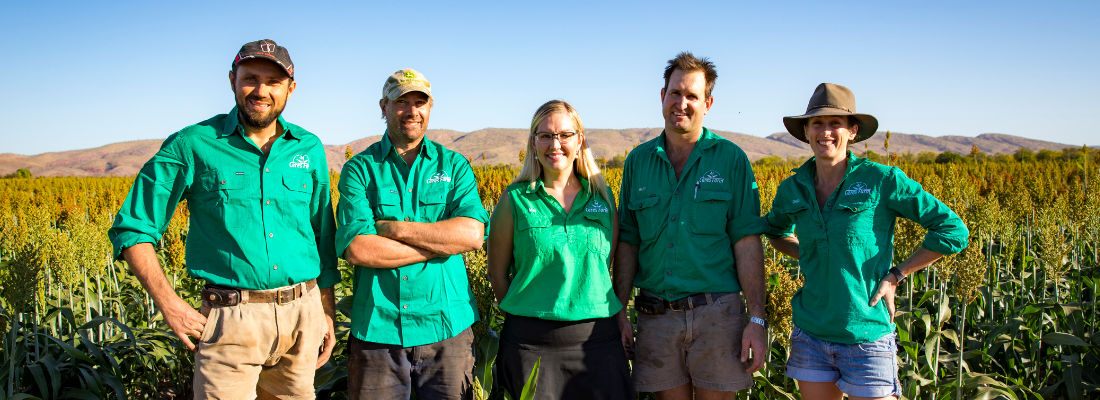 Five Ceres Farm team members standing in a sorghum crop with the Kimberley ranges behind