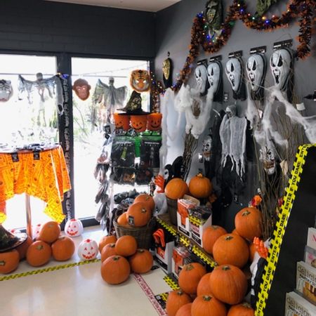 A shop display of Halloween pumpkins and Halloween decorations